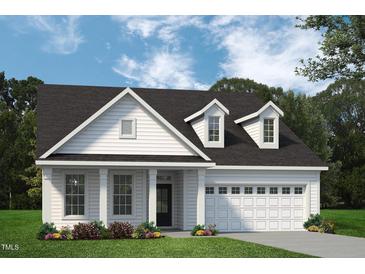 Charming new construction home featuring a welcoming two-car garage and manicured lawn at 702 Beacon Hill Rd # 51, Lillington, NC 27546