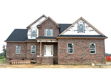 New construction two-story home featuring brick facade, white door and window frames, and a dark roof at 7491 Sweetwater Dr, Nashville, NC 27856
