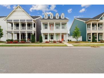 Charming two-story home featuring double porches, a white facade, and colorful doors at 1211 Gloriosa St, Apex, NC 27523