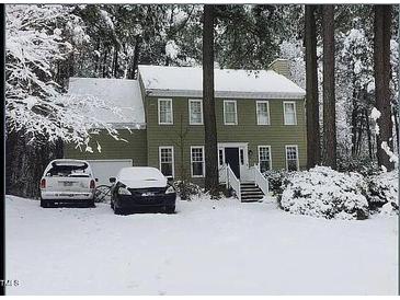 Charming two-story home with a traditional design is beautifully covered in fresh snow at 14 Striding Ridge Ct, Durham, NC 27713
