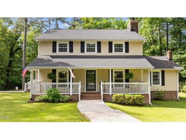 Charming two-story home featuring a welcoming front porch, black shutters, and a well-maintained lawn at 148 Shadowbrook Dr, Henderson, NC 27537