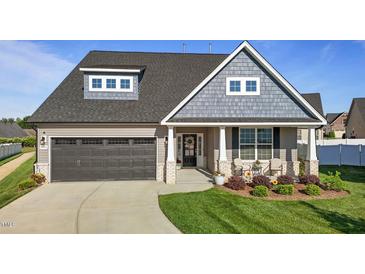 Beautiful two-story home featuring a well-manicured lawn, covered porch, and a two car garage at 2096 Dowell Ct, Burlington, NC 27215
