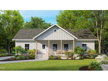 Charming single-story home with a welcoming front porch and lush landscaping at 3188 Williams Ln, Graham, NC 27253