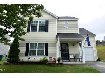 Charming two-story home featuring a well-maintained lawn and inviting front porch at 3848 Griffis Glen Dr, Raleigh, NC 27610