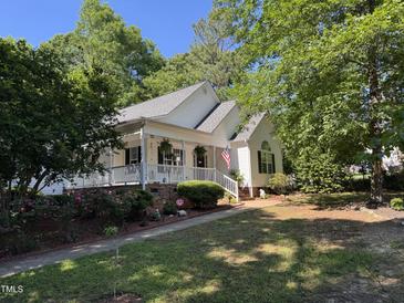 Charming single-Gathering home featuring a welcoming porch and landscaped front yard at 50 Peggy Ct, Raleigh, NC 27603