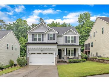 Beautiful two-story home with gray siding, black shutters, and a well-manicured lawn at 5412 Robbins Dr, Raleigh, NC 27610