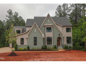 Two-story home with painted brick, gabled roof, and arched front entry at 7932 Wexford Waters Ln, Wake Forest, NC 27587