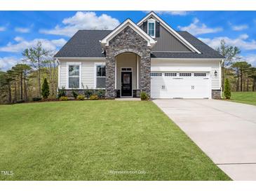 Charming two-story home with stone accents, attached two-car garage, and a well-maintained lawn at 87 Addison Pond Ct # 12, Zebulon, NC 27597