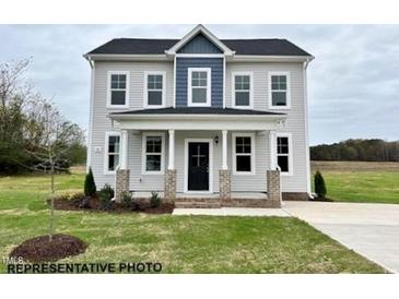 Charming two-story home featuring a welcoming front porch and neatly manicured lawn at 116 Legolas Ct, Middlesex, NC 27557
