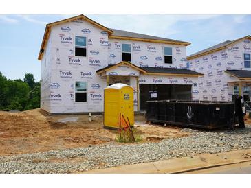 New construction home with Tyvek wrap, portable toilet, and dumpster at 2234 Cherry Creek Rd, Haw River, NC 27258