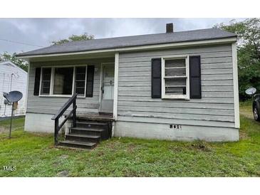 Quaint single-story home featuring horizontal siding and an inviting front entrance at 246 Keene St, Henderson, NC 27536