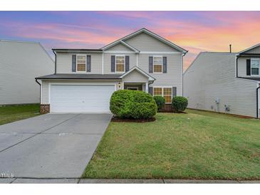 Charming two-story home with a manicured lawn and a two car garage at 2530 Girvan Dr, Fuquay Varina, NC 27526