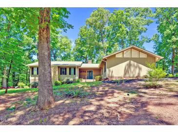 View of the home's exterior showcasing its charming curb appeal and mature landscaping at 3216 Green Valley Dr, Sanford, NC 27330