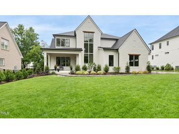 Stunning two-story home with a lush green lawn and manicured landscaping that enhances its curb appeal at 3407 Churchill Rd, Raleigh, NC 27607