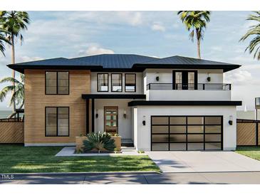 Stunning two-story home with modern design, wood accents, and a black-trimmed garage door at 3801 Peaceful Creek Trl, Zebulon, NC 27597
