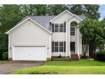 Charming two-story home with vinyl siding, well-maintained landscaping, and a two-car garage at 5629 Yates Garden Ln, Raleigh, NC 27606