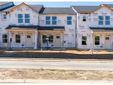 New construction townhomes with Tyvek wrap, ready for customization and finishing touches at 715 Chandler Stone Dr, Zebulon, NC 27597