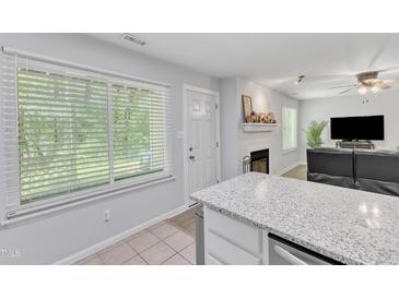 Bright eat-in kitchen features stainless appliances, granite counters and an abundance of natural light at 101 Oyster Bay Ct # B2, Cary, NC 27513