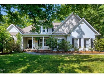 Charming home featuring a welcoming front porch, manicured landscaping and classic architectural details at 108 Ellsworth Pl, Chapel Hill, NC 27516