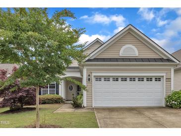 Charming single-story home with a well-manicured lawn and a two-car garage at 113 Dowington Ln, Cary, NC 27519