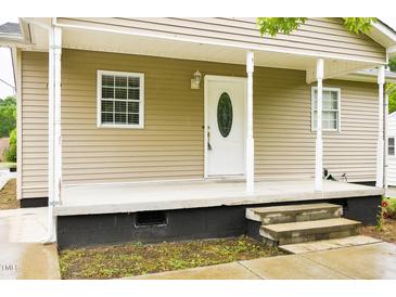 Inviting covered front porch with classic white columns and steps leading to the front door at 1309 Jackson St, Burlington, NC 27217