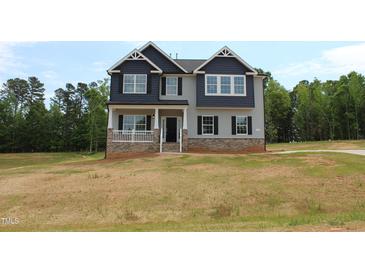 Charming two-story home with a welcoming front porch and a mix of brick and siding exterior at 1406 Reading Ct # 93 Kl, Burlington, NC 27217