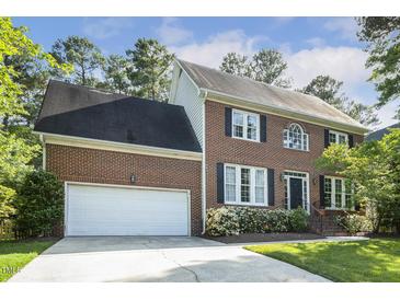 Charming two-story brick home featuring an attached two-car garage and a beautifully landscaped front yard at 1601 Castalia Dr, Cary, NC 27513