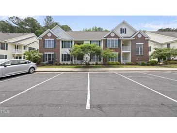 Charming two-story condo with brick and white siding and well-maintained landscaping at 1723 Kudrow Ln, Morrisville, NC 27560