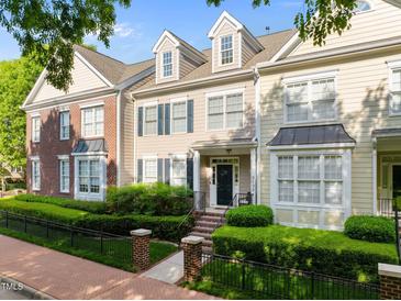 Charming townhome with a manicured lawn, brick accents, and a welcoming front porch with brick steps at 2503 Saint Pauls Sq, Raleigh, NC 27614
