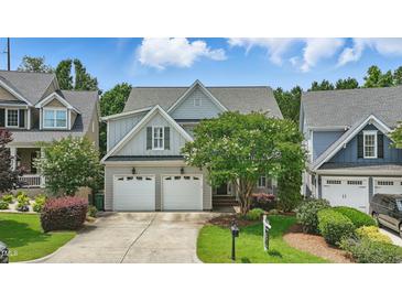 Charming two-story home with a well-manicured lawn and a two-car garage at 2721 Cameron Pond Dr, Cary, NC 27519