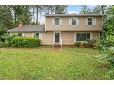 Charming two-story home featuring a well-maintained lawn and traditional architectural details at 4812 Kaplan Dr, Raleigh, NC 27606
