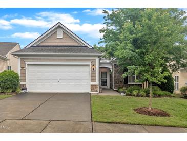 Charming single-story home with a manicured lawn, two-car garage, and stone-lined entryway at 804 Harsworth Dr, Cary, NC 27519