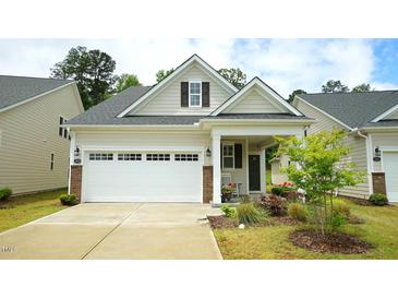 Charming home featuring a two-car garage, inviting front porch, and well-maintained landscaping at 1009 Morrison Dr, Durham, NC 27703