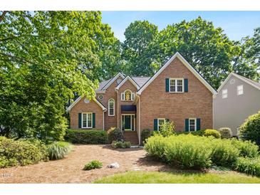 Charming brick home with lush landscaping, gabled roof, and inviting curb appeal at 1025 Kingsway Dr, Apex, NC 27502