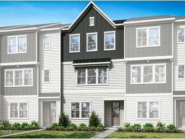 Charming townhome showcasing a well-maintained lawn and inviting facade at 1038 Zelkova Ln, Chapel Hill, NC 27517