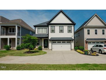 Charming two-story home featuring a two-car garage and beautifully landscaped front yard at 134 Cotten Dr, Morrisville, NC 27560