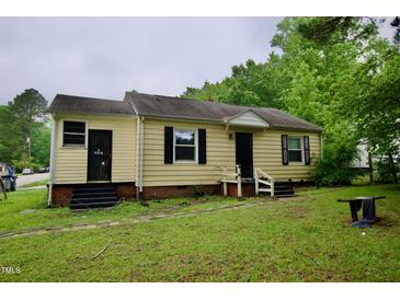 A charming single-story home with black shutters and a well-maintained lawn on an overcast day at 1620 Old Wilson Rd, Rocky Mount, NC 27801