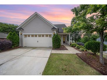 Charming home featuring a two-car garage, and beautifully landscaped front yard at 219 Rosedale Creek Dr, Durham, NC 27703