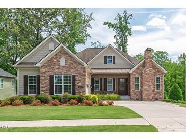 Charming, single-story home featuring a stone facade, manicured lawn, and inviting covered entrance at 2633 Beckwith Rd, Apex, NC 27523