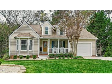 Charming home with beige siding, bay window, covered porch, and an attached one car garage at 318 Tillamook Dr, Wake Forest, NC 27587