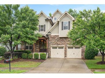Charming two-story home with stone accents, a two-car garage, and mature landscaping at 821 Laurel Garden Way, Cary, NC 27513