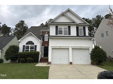 Charming two-story home with a two car garage, complemented by a well-maintained lawn and garden at 10 Gwendolyn Cir, Durham, NC 27703