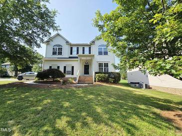 Charming two-story home featuring a manicured lawn, mature trees, and a welcoming front entrance at 1039 Bellenden Dr, Durham, NC 27713