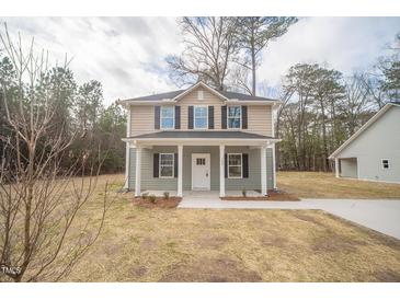 Inviting two-story home features a charming front porch and beautifully landscaped yard at 112 Ambergate Ct, Rocky Mount, NC 27804