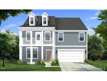 Charming two-story home featuring gray siding, a two-car garage, dormer windows, and a quaint front yard at 168 Copperleaf Court, Franklinton, NC 27525