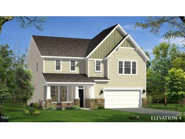 Charming two-story home featuring stone accents, a covered porch, and an attached two-car garage at 173 Copperleaf Court, Franklinton, NC 27525