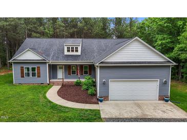 Charming one story home featuring a two-car garage, landscaped front yard, and inviting curb appeal at 1850 Willie Pace Rd, Burlington, NC 27217