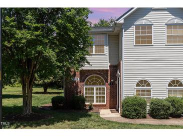Charming two-story home featuring beautiful windows, manicured lawn, and verdant landscaping at 2111 Piney Brook Rd # 101, Raleigh, NC 27614