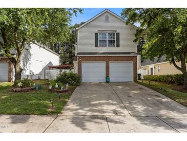 Charming two-story home featuring a two-car garage, brick accents, and well-manicured landscaping at 4216 Lake Woodard Dr, Raleigh, NC 27604