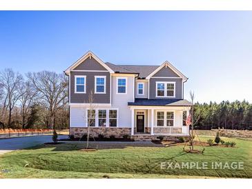 Charming two-story home with a welcoming front porch and well-manicured lawn at 448 Golden Dragonfly St, Wake Forest, NC 27587